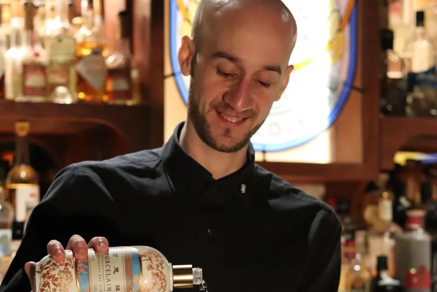 A bartender pouring Porcelain Gin.